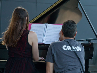 Another hazard of playing outside:  the wind might blow your sheet music.  Luckily, the stage crew stepped in.