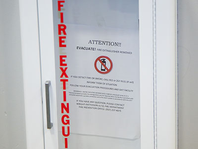 The fire extinguishers have been removed, replaced by a piece of paper that says EVACUATE!