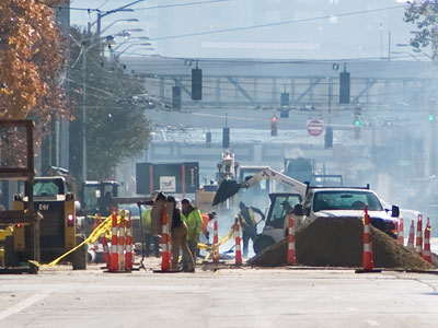 A typical street scene in Dayton, as PERFECTLY GOOD water pipes from the 1880s are being replaced.