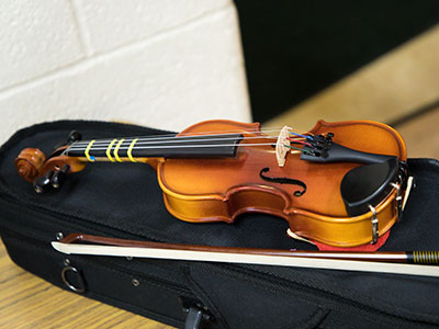 A tiny violin for a tiny violinist.