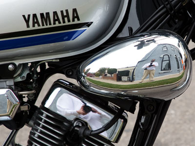 An illegally-parked motorcycle (oh, and me reflected three times).