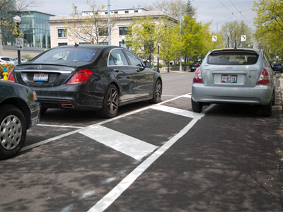 Dayton struggles with the new parking spaces (see March 8, 2021).  Did they both put money in the meter?