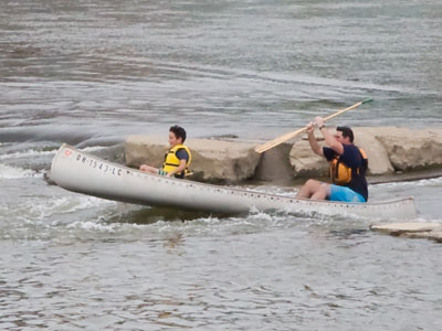 The kid was having fun while the dad paddled like crazy.