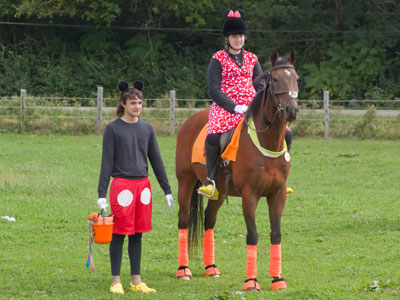 The orange pail he`s holding means they won a prize in the costume contest.