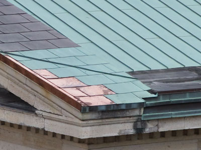 Copper roof tiles in various stages of oxidation.