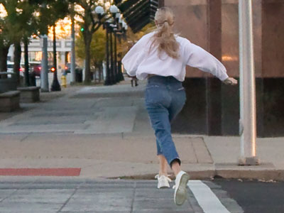 A young woman sprints to catch the bus, while I walk casually and think, `Oh well, there will be another one.`