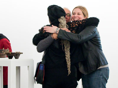 Their three-way hug nearly knocked over that sculpture.