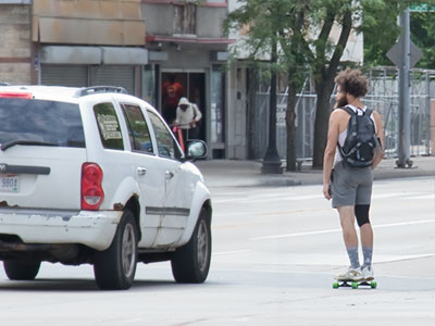 Not surprisingly, the skateboarder in the street got honked at.