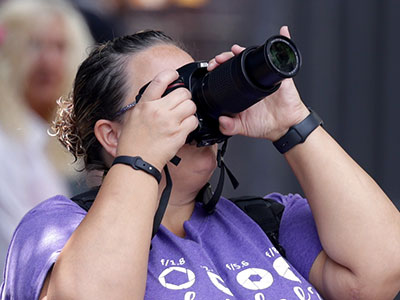 She has aperture settings on her t-shirt.