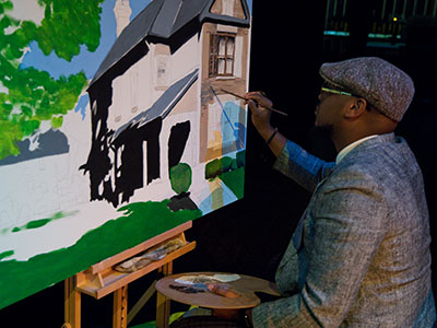 Today a celebration of the 150th birthday of Paul Laurence Dunbar took place at the Victoria Theatre.  Artist Angelo Hobson spent hours on the stage painting a picture of the Dunbar House.