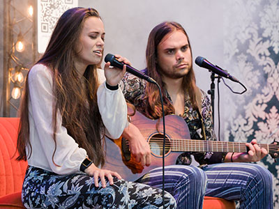 During the pandemic, this duo practiced in the basement on an orange couch, so they brought it with them on tour.