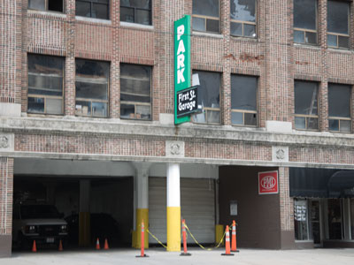 The latest danger at my parking garage:  that big sign seems to be coming loose from the wall.