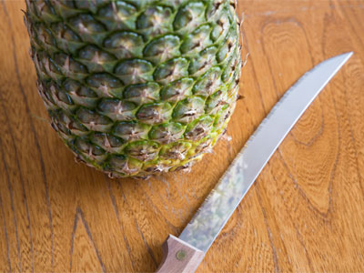 The challenge is to slice the pineapple, not my fingers.