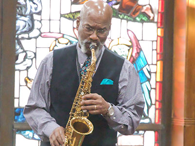 Reginald Harmon played his saxophone during the ceremony.