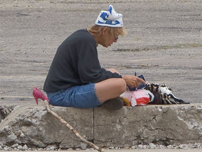 Is this the mystery person who keeps putting high heel shoes at that spot?  I drove by and decided probably not.