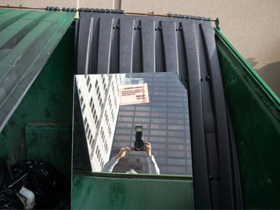 Found in a dumpster is a dressing room mirror from a department store that closed decades ago.