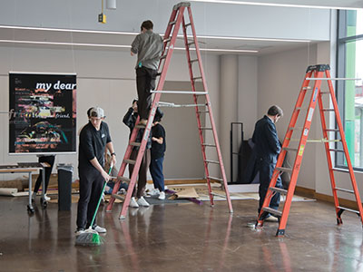 Graphic design students from the University of Dayton created the posters and then hung them in the gallery.