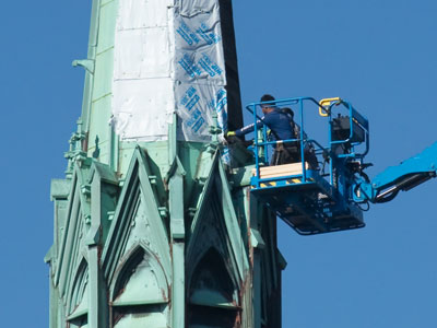 As I stood on the sidewalk photographing these workers, a drone flew above them probably shooting video.