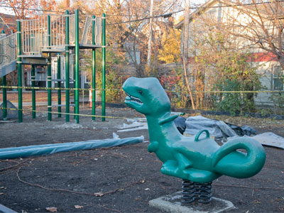 The dinosaur looks hungrily at the new playground equipment (October 26, 2023).