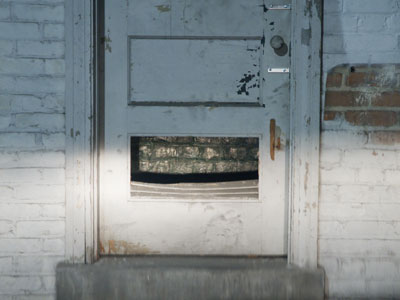 Somebody broke through this door near where I park my car (see December 4 above).  To get in our out?