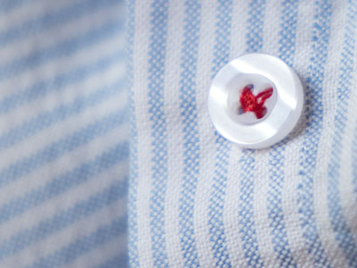 A sewed a button back on with red thread.  I have reached that age where I don`t care what people think.