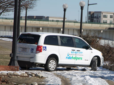 There`s a van on the sidewalk in front of me.  Bonus:  it`s stuck in the ice and spinning its wheels.