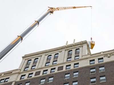 There are many cranes and lifts in the downtown area.