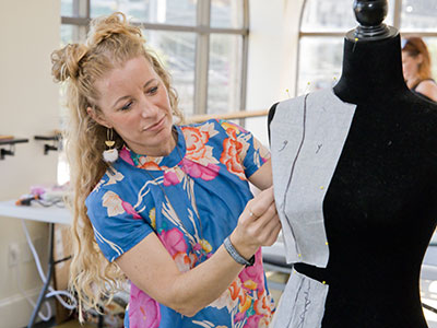 At 12:40pm a clothing designer is hard at work. At 12:40pm a clothing designer is hard at work.