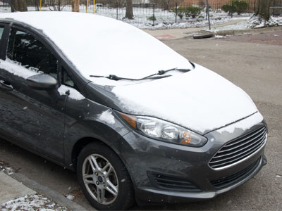 Snow stuck to the car, and to me.