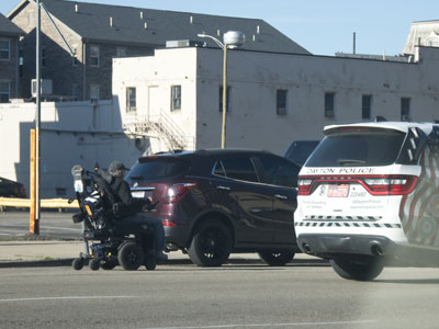 Dayton cops stop to give advice to this person rolling down the street in a wheelchair.