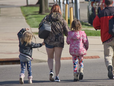Mommy dearest walked along with a burning cigarette in front of her little girl`s face.